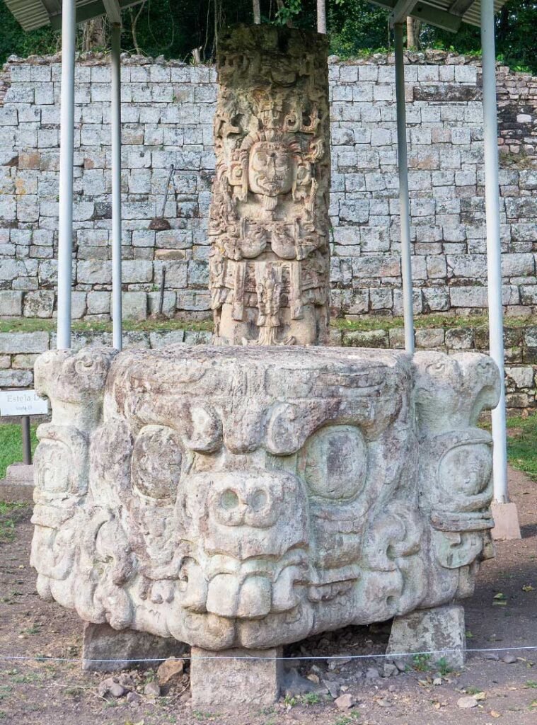Stela D and its circular altar in the Great Plaza of the Copán UNESCO archaeological site, part of the Copán day tour from Guatemala City by air for travelers who fly from Guatemala to Copán to explore ancient Maya monuments.